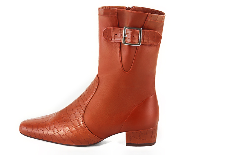 Terracotta orange women's ankle boots with buckles on the sides. Round toe. Low block heels. Profile view - Florence KOOIJMAN